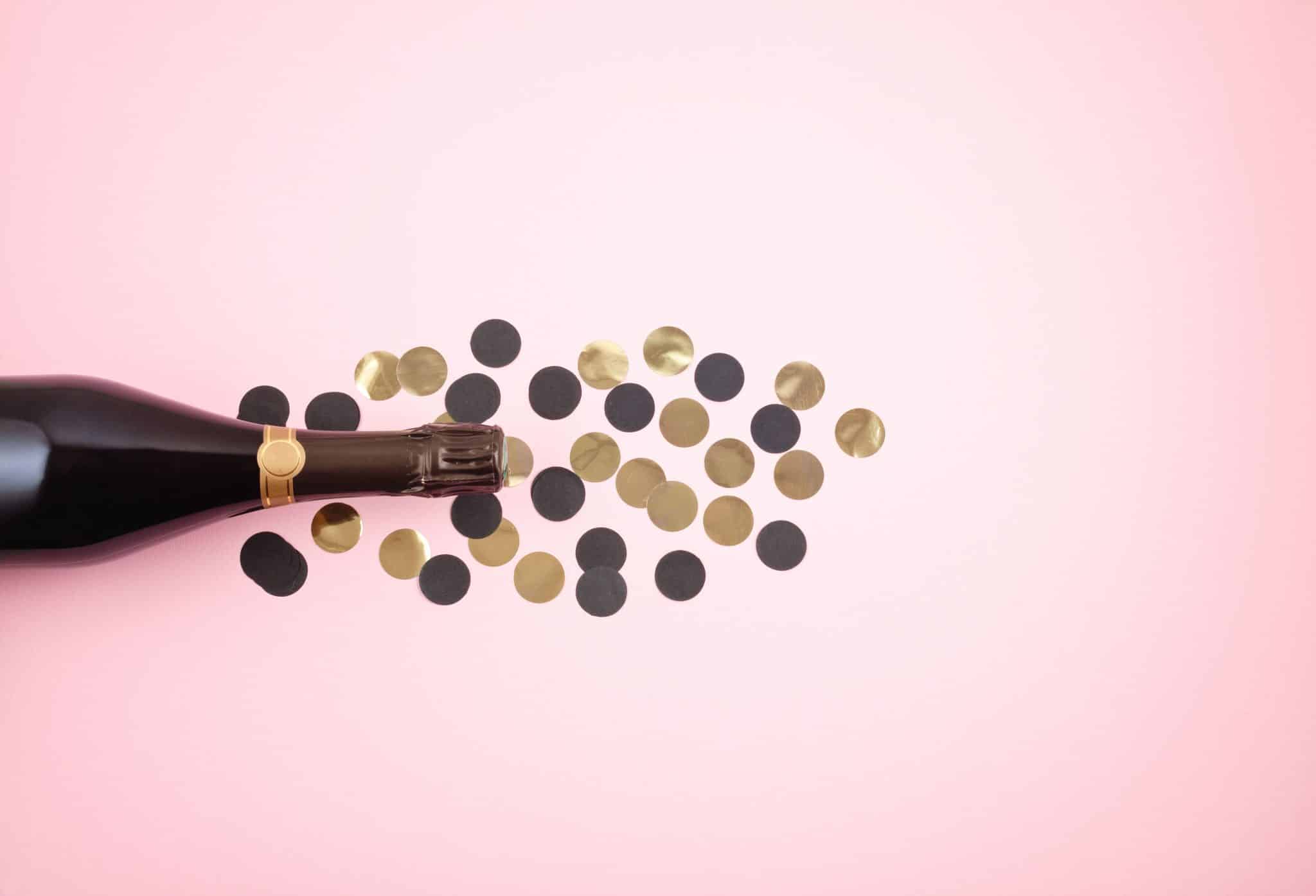 wine bottle kept on the table with coins showcasing the pricing point of the selection