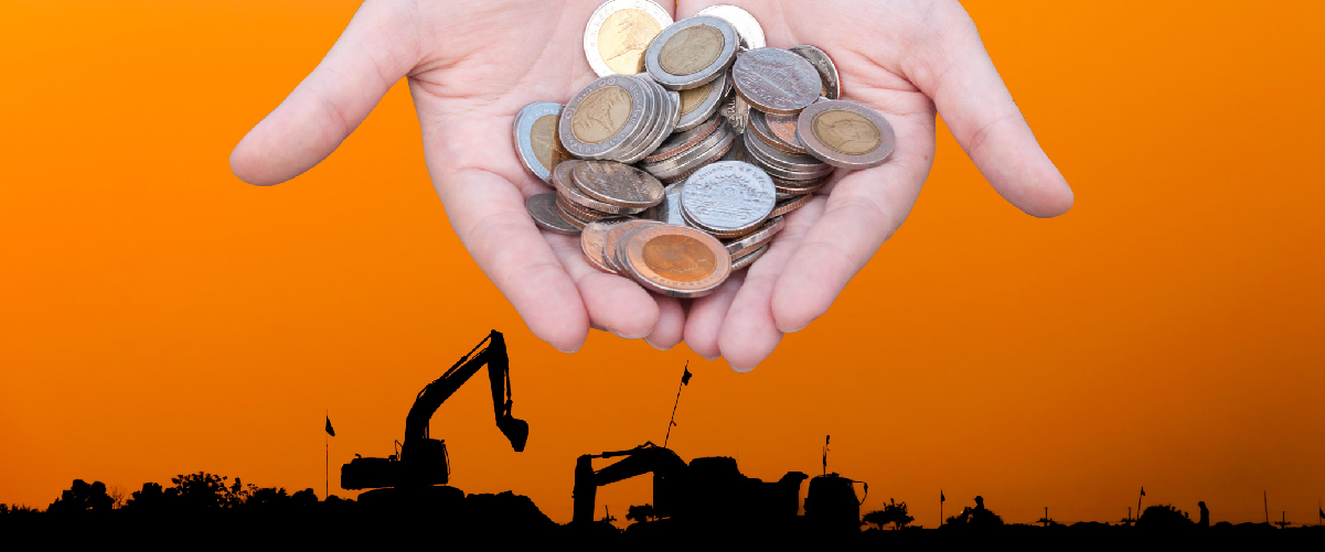 Hands holding coins with construction equipment silhouette in the background, symbolizing labor costs in the workforce