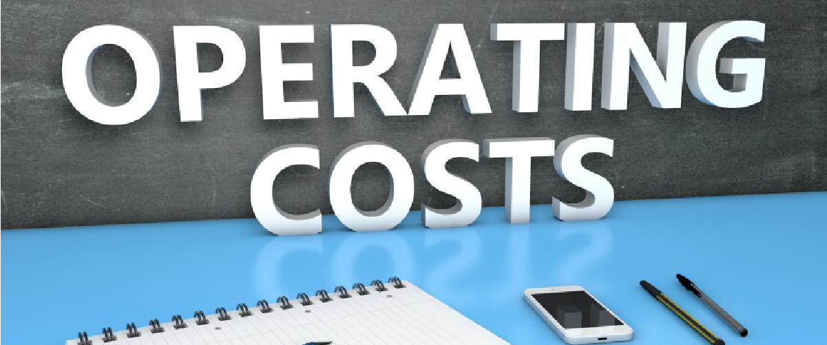  ext reading 'Operating Costs' on a blackboard with a desk setup including a notebook, smartphone, and pens, representing expense management